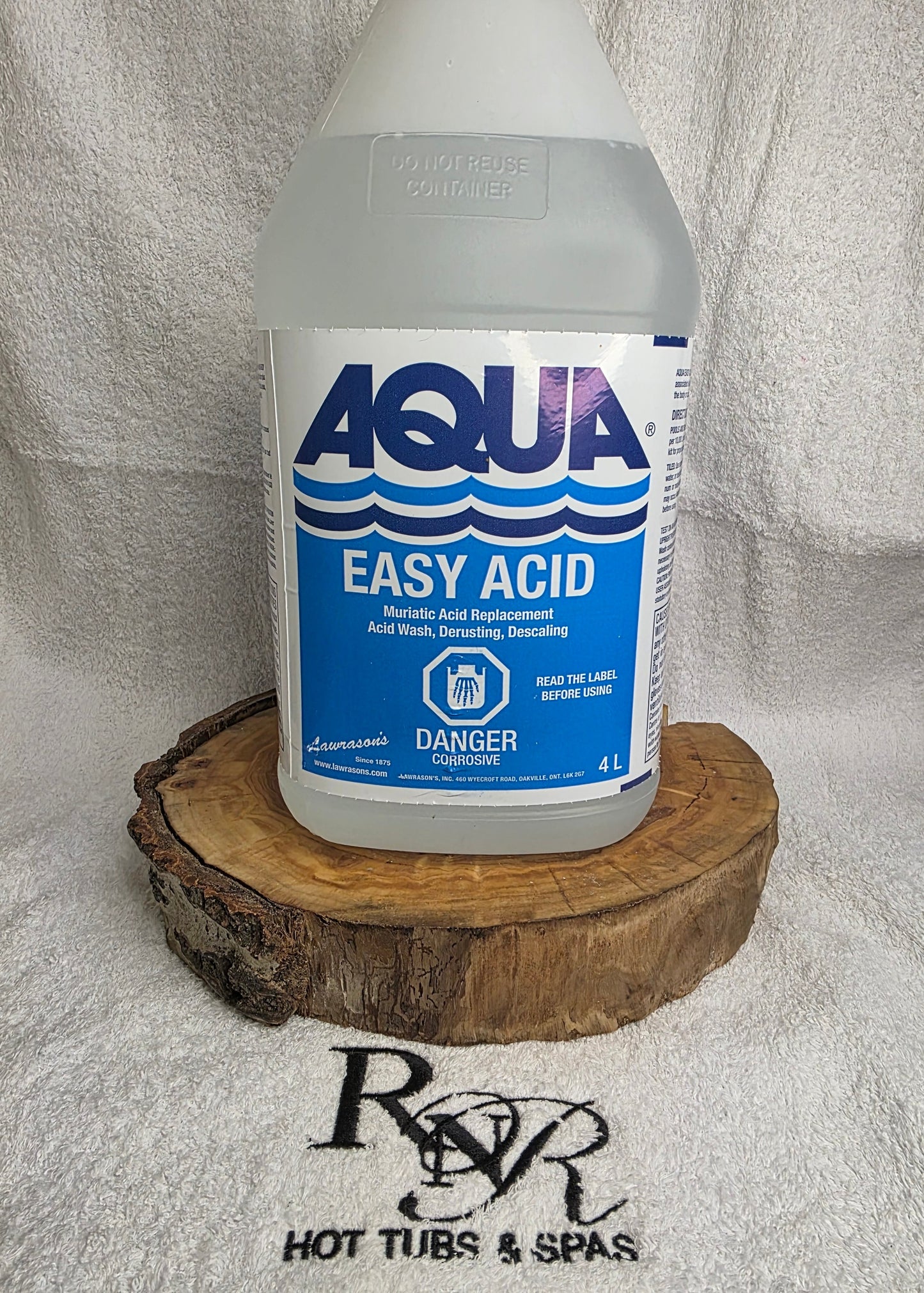 Bottle of Aqua Easy Acid on a white towel with a wooden block underneath, branded RnR Hot Tubs & Spas.
