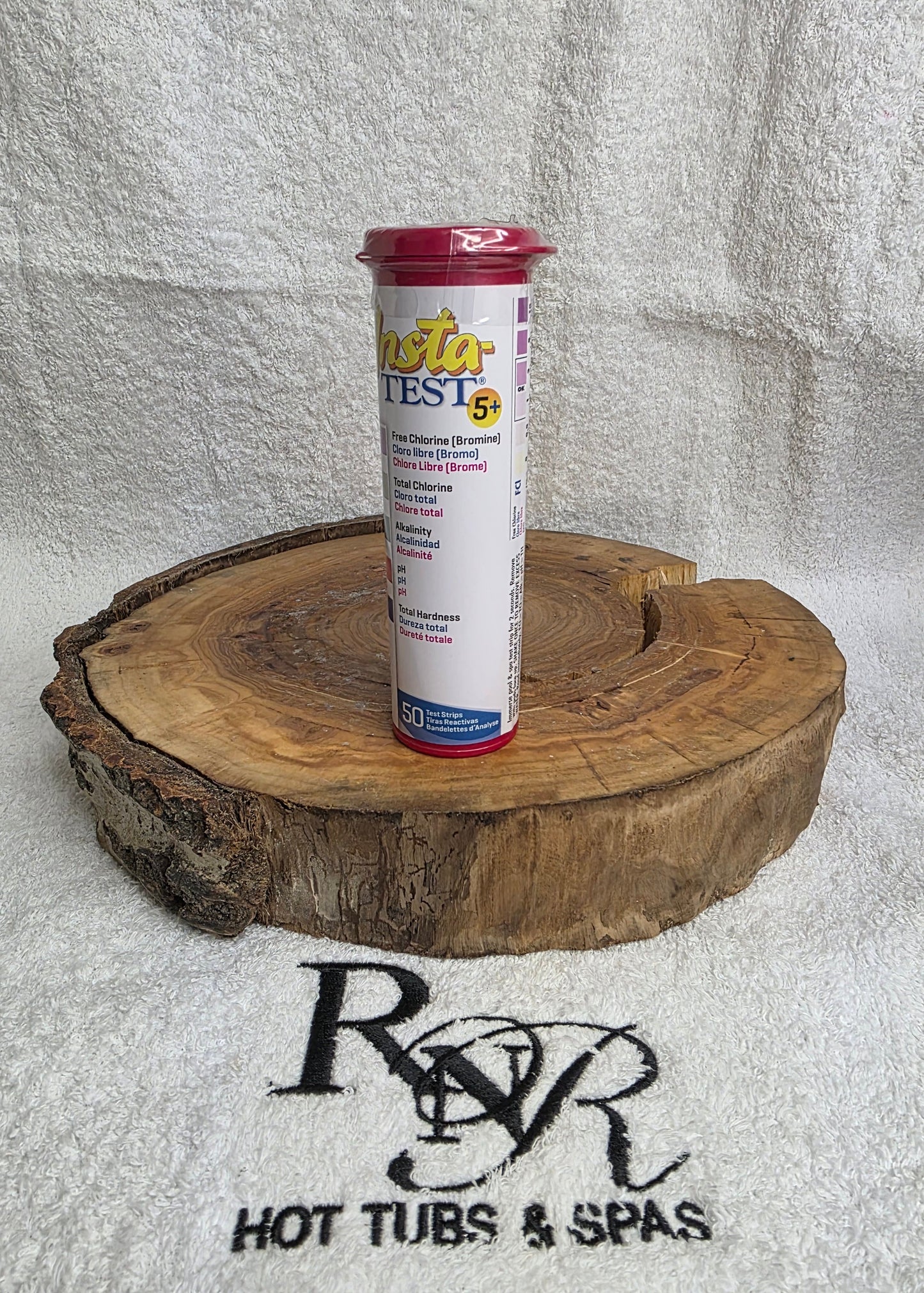 Test strip on a wooden block with RnR Hot Tubs & Spas branding in the background.