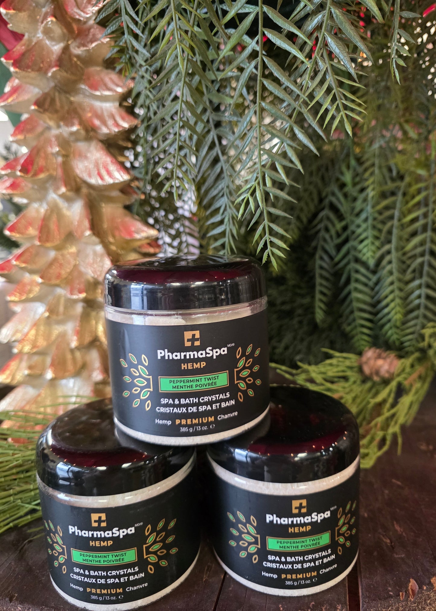 Three jars of PharmaSpa product on a decorative surface with greenery