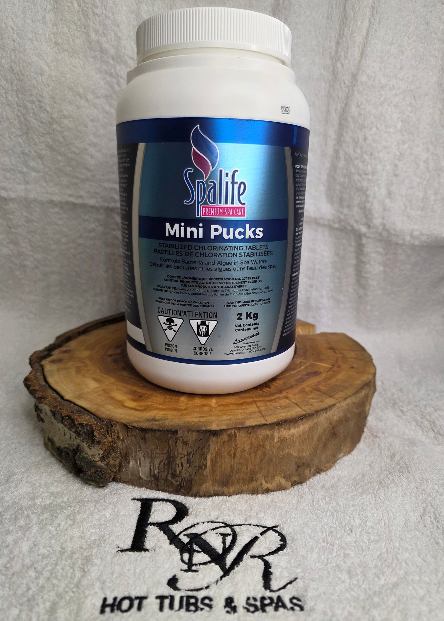Spalife product container with a wooden brush on a towel with RnR Hot Tubs and Spas branding.