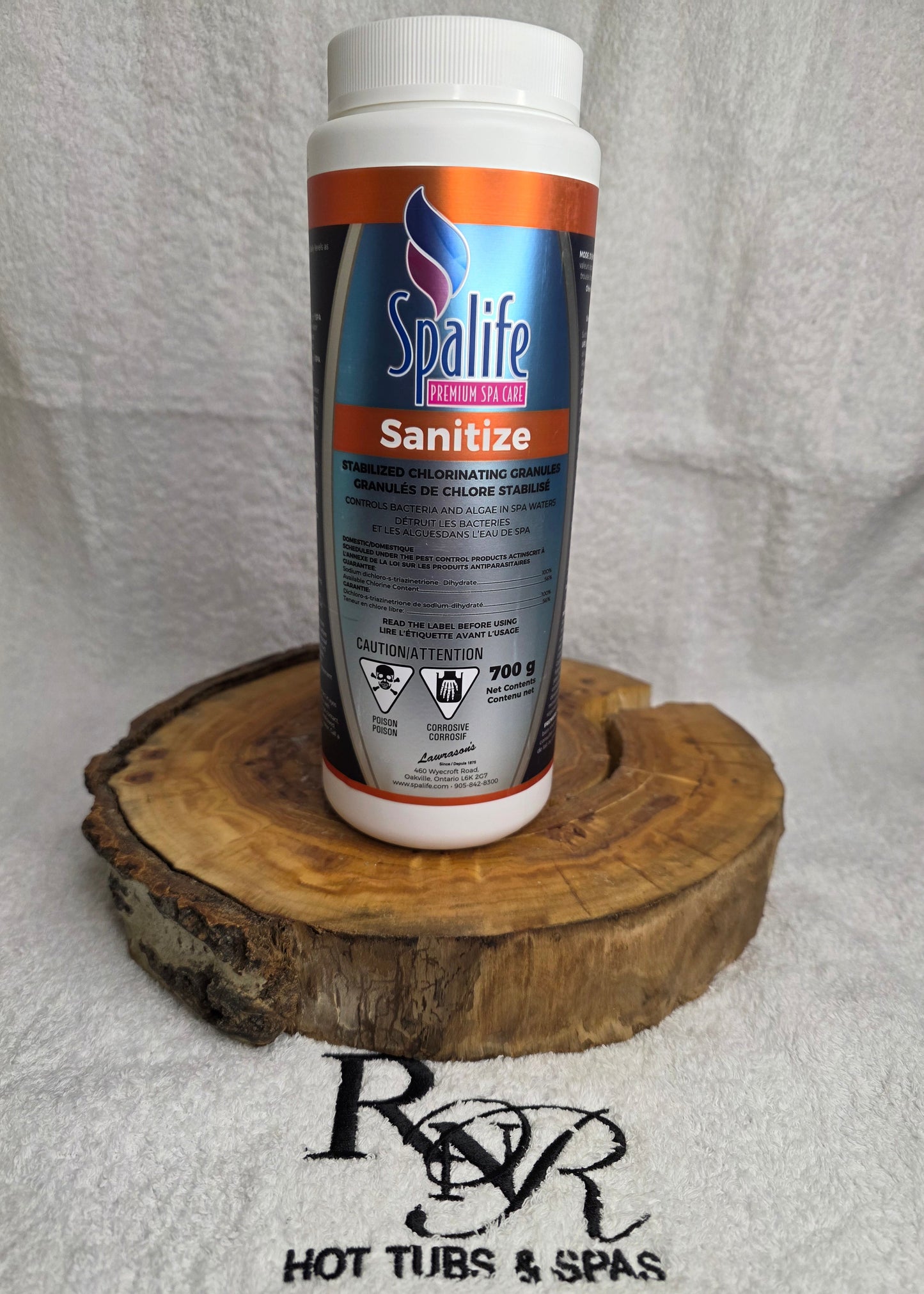 Spalife Sanitize bottle on a wooden block with a brand logo in the background
