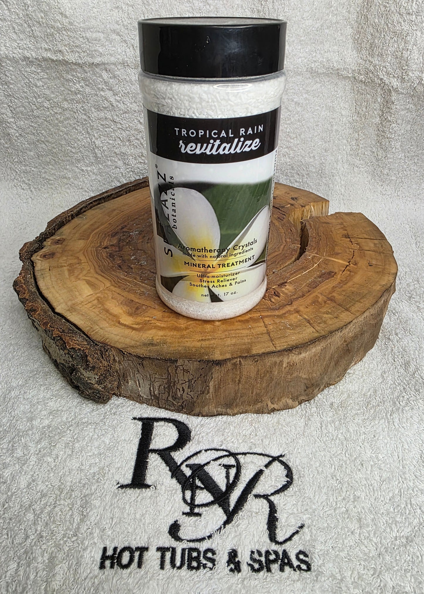 Spazazz Revitalize aromatherapy crystals on a wooden block with RnR Hot Tubs & Spas branding in the background
