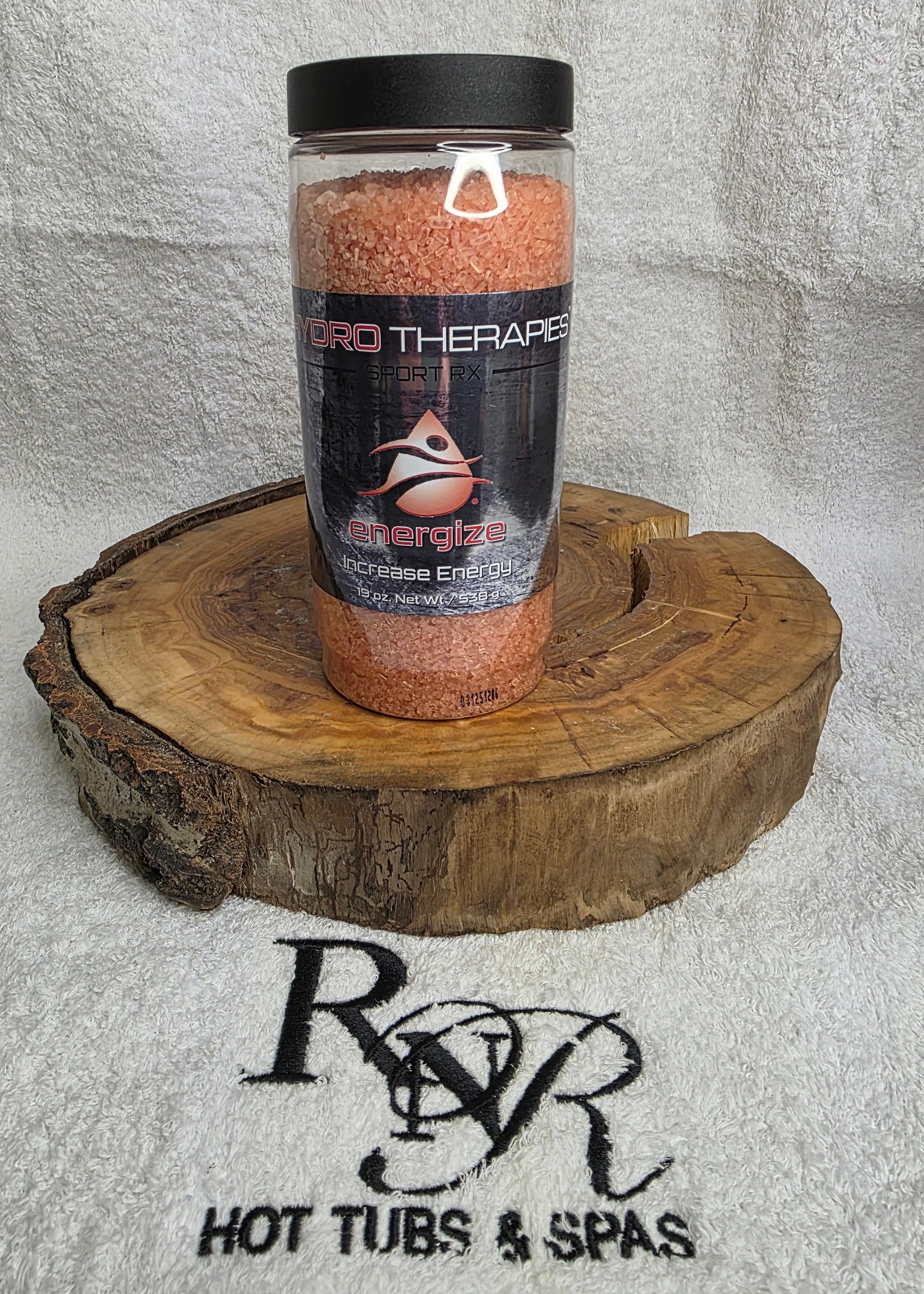 Bottle of Hydro Therapies on a wooden block with RnR Hot Tubs & Spas logo in the background