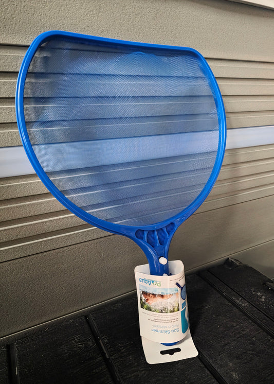 Spa Leaf Skimmer With Rubber Handle against a hot tub and on top of black stairs.