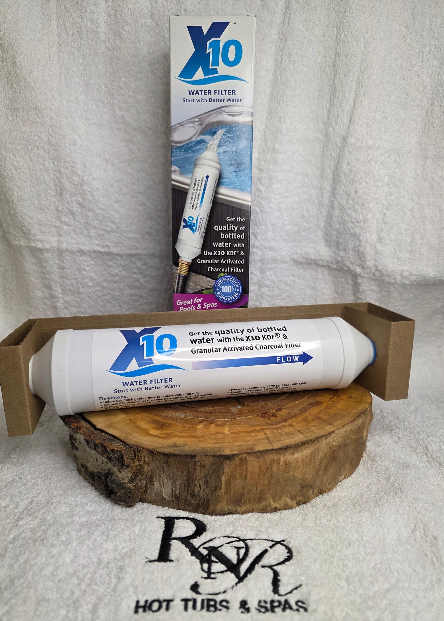 X10 product on a wooden block with packaging on a towel, branded RnR Hot Tubs and Spas.