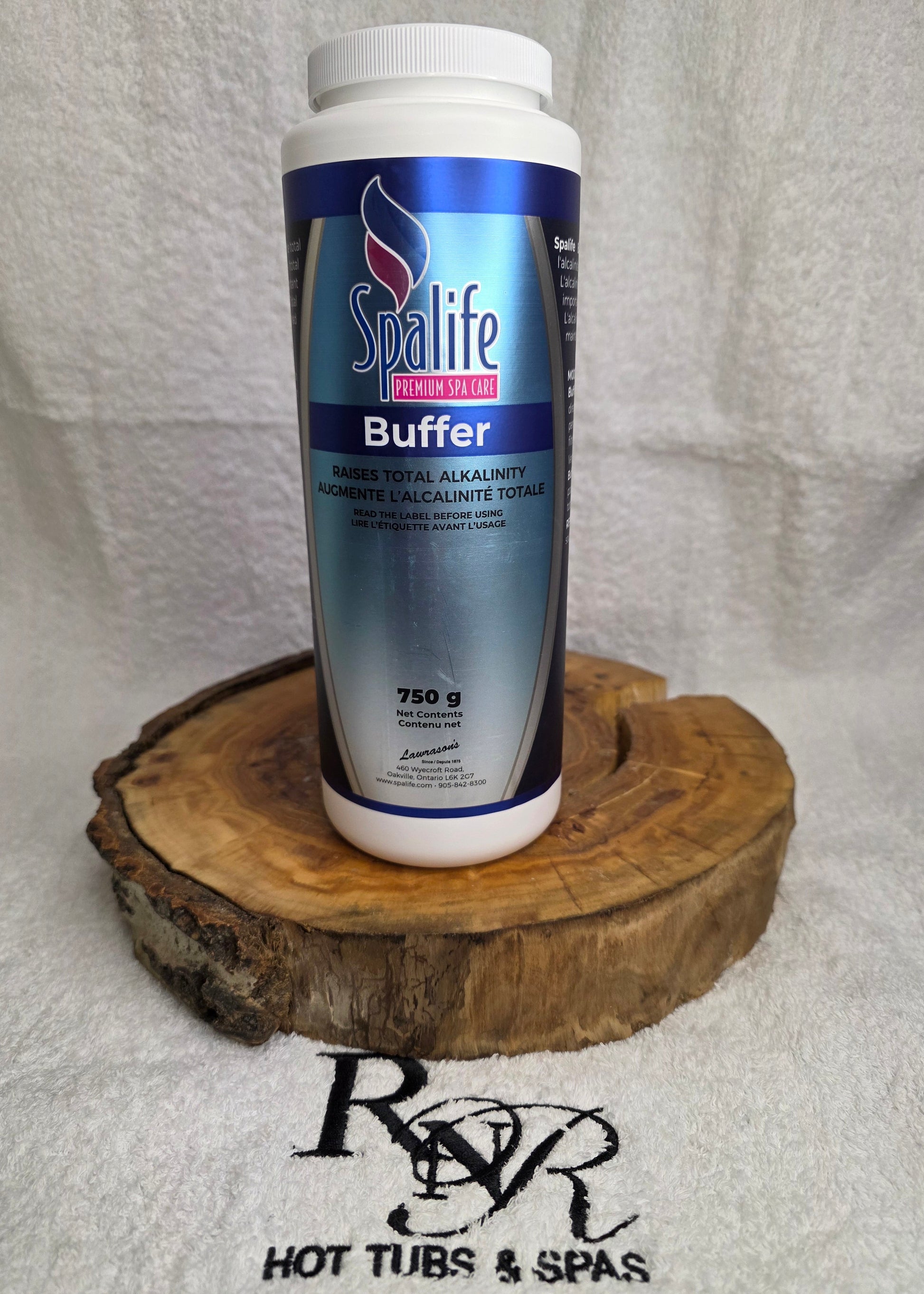 SpaLife Buffer bottle on a wooden block with a towel background