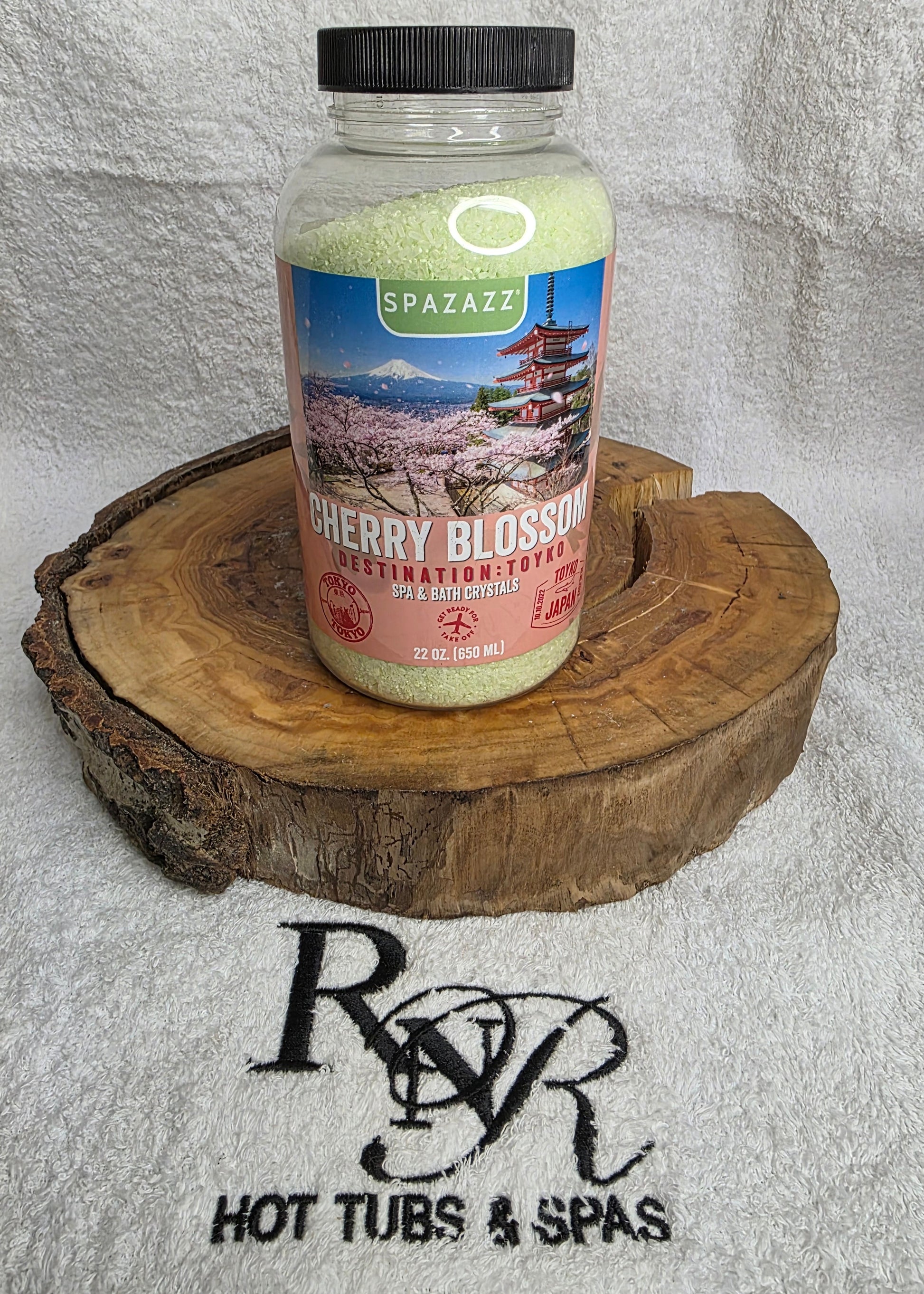 Spazazz Destinations Tokyo Cherry Blossom aromatherapy crystals on a wooden block with RnR Hot Tubs & Spas logo in the background.