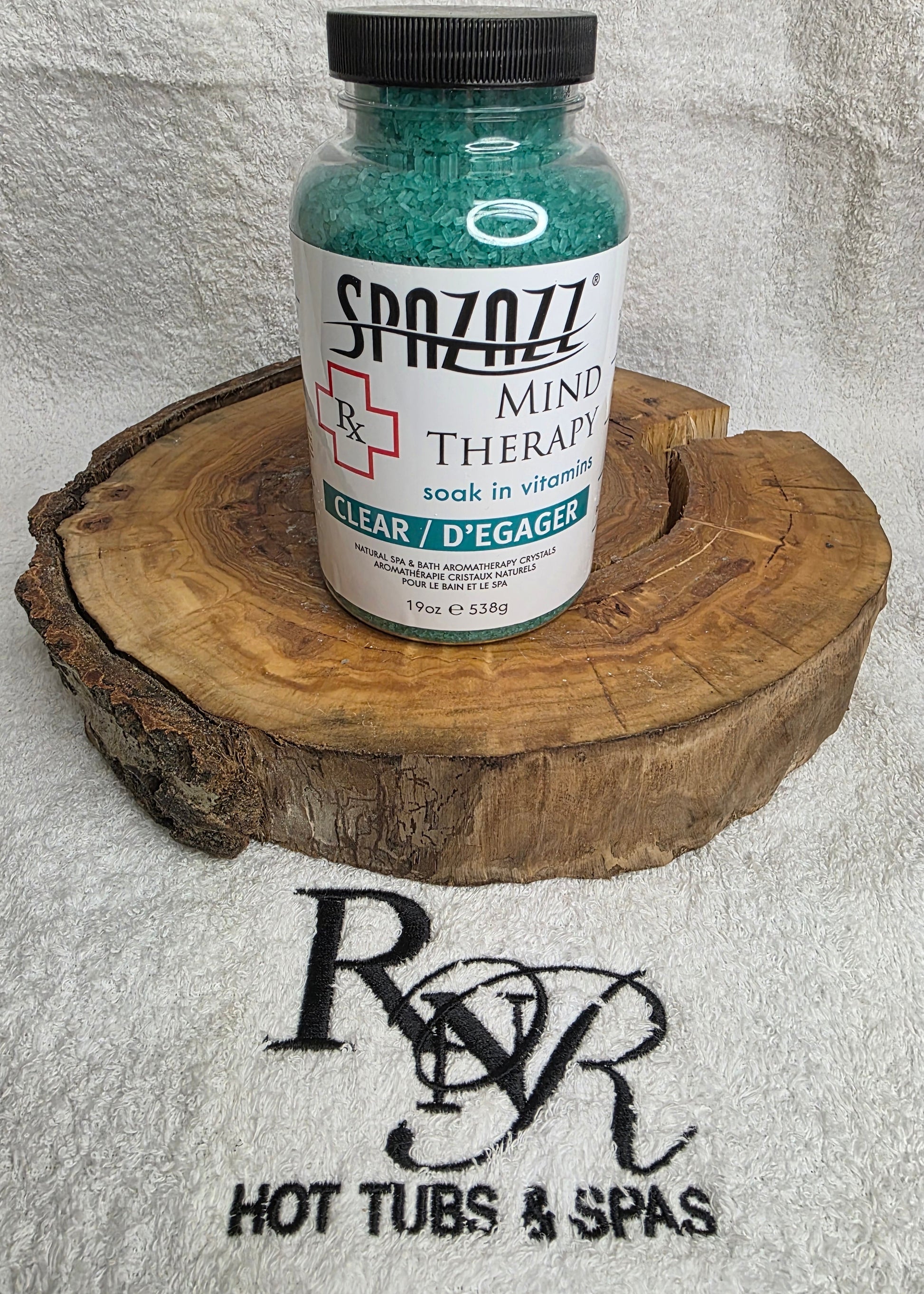 Bottle of Spazazz Mind Therapy on a wooden block with a visible brand logo at the bottom.