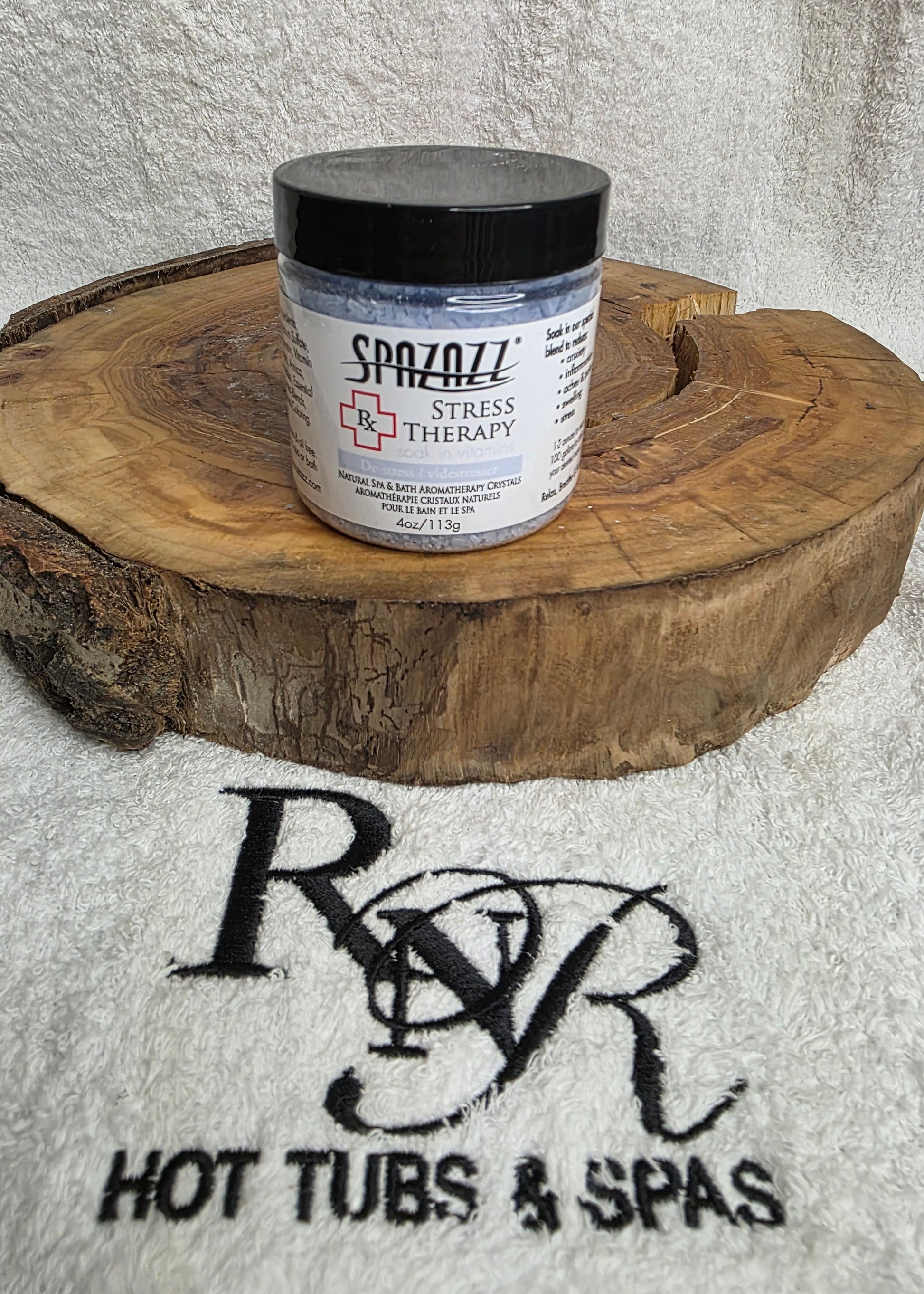 Spazazz Stress Therapy aromatherapy crystals on a wooden block with RnR Hot Tubs & Spas logo in the background